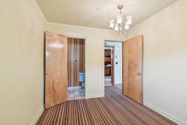 909 Hillsboro Rd, Franklin, TN 37064 - hallway with baseboards, carpet, and a notable chandelier