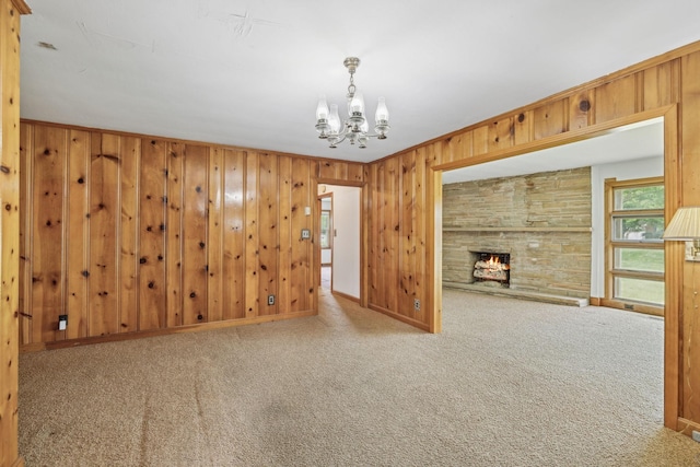 909 Hillsboro Rd, Franklin, TN 37064 - interior space with wood walls, a notable chandelier, a stone fireplace, and baseboards