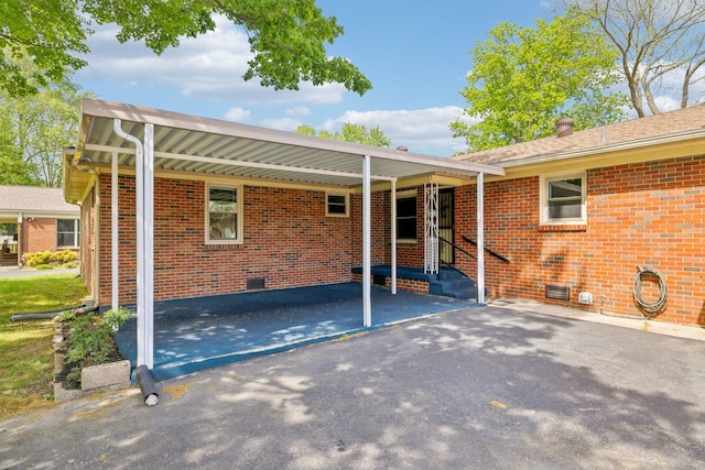 909 Hillsboro Rd, Franklin, TN 37064 - back of property featuring crawl space, aphalt driveway, an attached carport, and brick siding