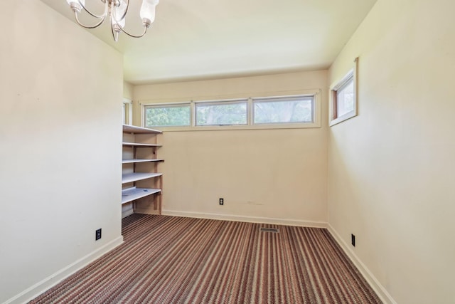 909 Hillsboro Rd, Franklin, TN 37064 - carpeted spare room with baseboards and a notable chandelier