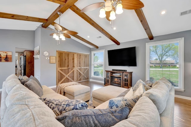 1803 W Lori Lee Dr, Gallatin, TN 37066 - living room featuring wood finished floors, visible vents, a ceiling fan, and lofted ceiling with beams