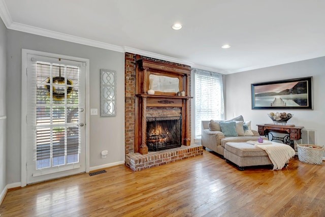 1803 W Lori Lee Dr, Gallatin, TN 37066 - living room featuring a brick fireplace, ornamental molding, light wood finished floors, and visible vents