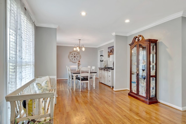 1803 W Lori Lee Dr, Gallatin, TN 37066 - dining area with a chandelier, light wood-style floors, crown molding, and baseboards
