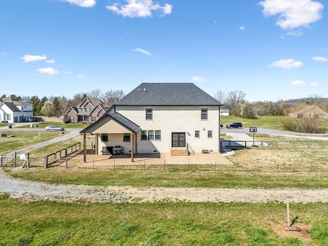 back of property with a patio area, entry steps, and roof with shingles