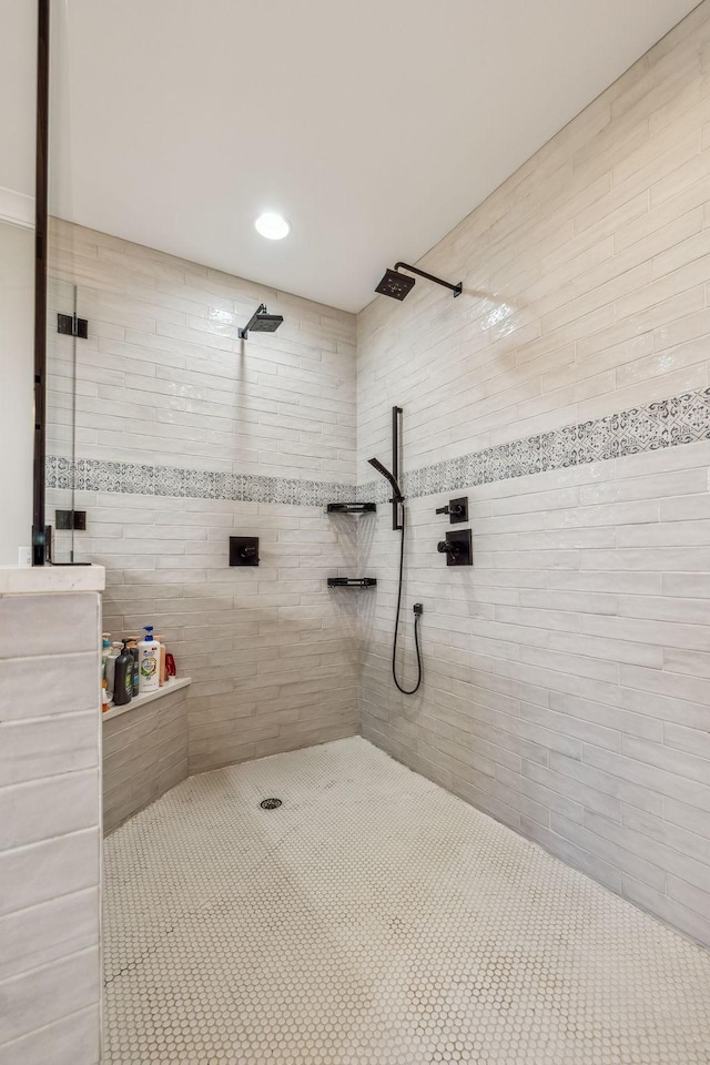 full bath with a tile shower