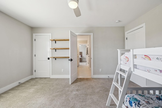 bedroom with light carpet, baseboards, and a ceiling fan
