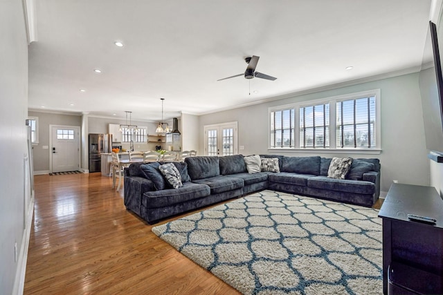 living area featuring ceiling fan, ornamental molding, wood finished floors, recessed lighting, and baseboards