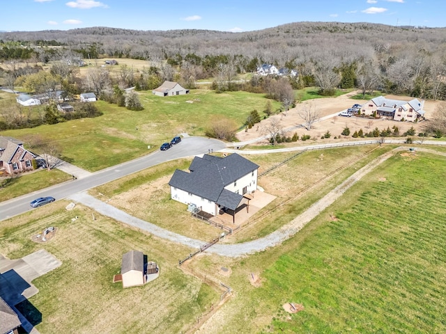 aerial view of property's location featuring a forest