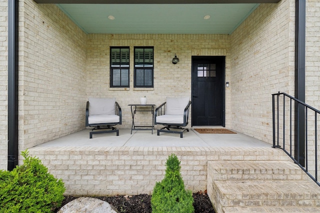 view of exterior entry with brick siding