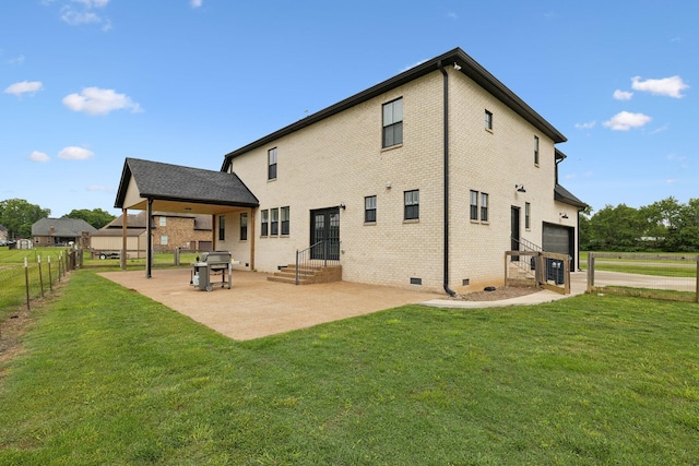 rear view of house featuring a patio, an attached garage, crawl space, and brick siding