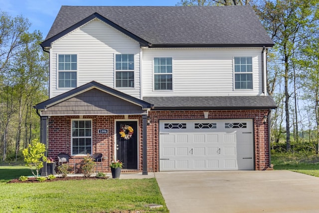 view of front of house with brick siding, roof with shingles, a front yard, and concrete driveway