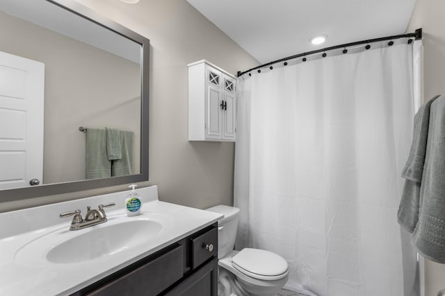 bathroom featuring vanity, curtained shower, and toilet