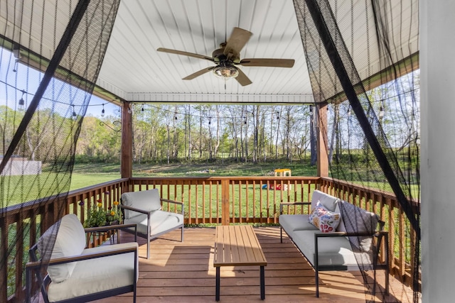 wooden terrace featuring ceiling fan and outdoor lounge area