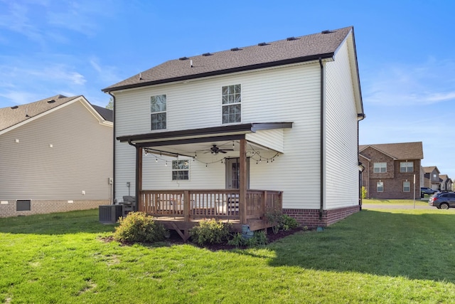rear view of house with a yard, a ceiling fan, central AC, and a deck