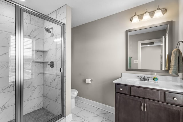 bathroom featuring toilet, a marble finish shower, vanity, marble finish floor, and baseboards