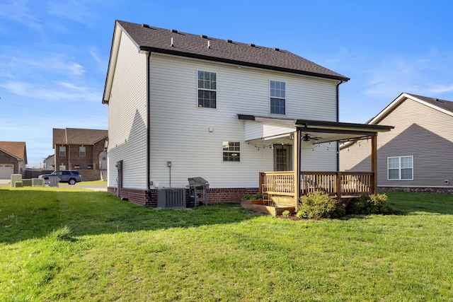 rear view of house featuring a yard