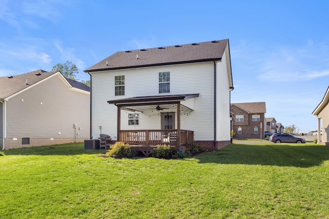 back of house with a lawn, a ceiling fan, a wooden deck, and cooling unit