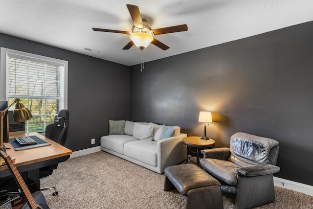 office featuring carpet flooring, a ceiling fan, baseboards, and visible vents