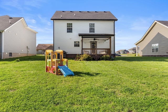 back of house with a lawn, ceiling fan, and a deck