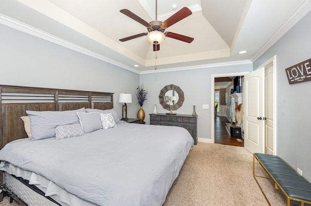 bedroom with recessed lighting, a raised ceiling, crown molding, baseboards, and carpet flooring