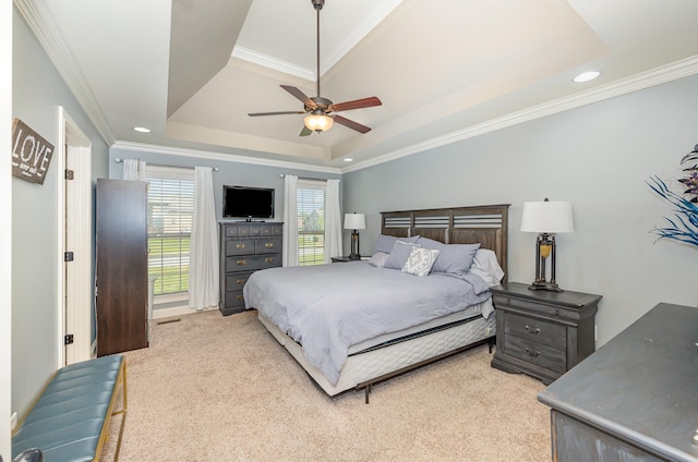 bedroom with light carpet, ornamental molding, and a raised ceiling