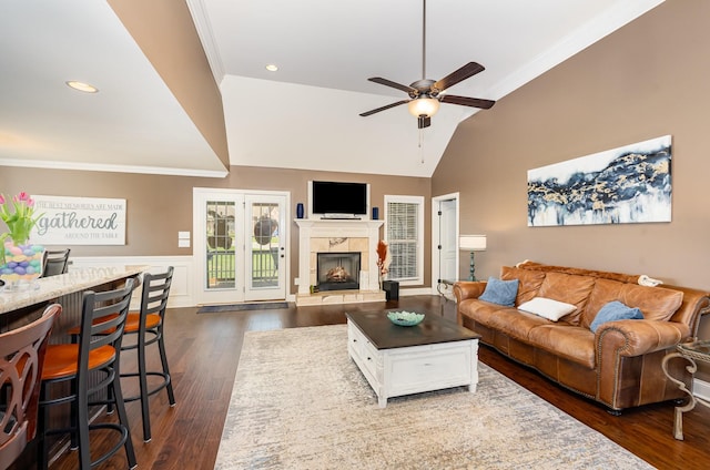 living room with vaulted ceiling, ornamental molding, ceiling fan, and dark wood-style flooring