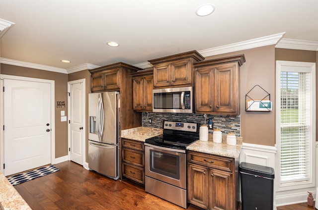 kitchen with decorative backsplash, dark wood-style floors, appliances with stainless steel finishes, and crown molding