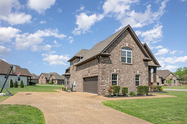 view of side of property with a lawn, brick siding, a residential view, and concrete driveway