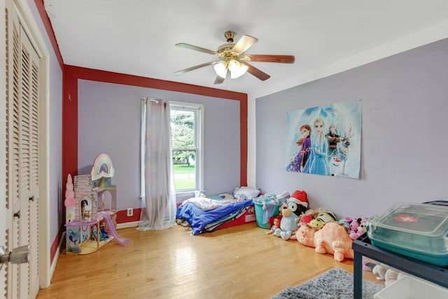 bedroom featuring wood finished floors, a closet, and ceiling fan