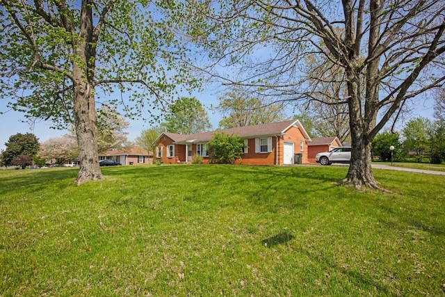 ranch-style house with an attached garage and a front yard