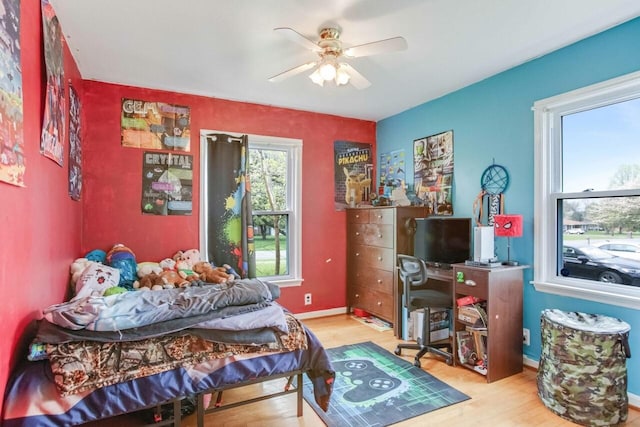bedroom with baseboards, a ceiling fan, and wood finished floors