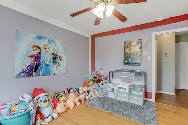 playroom with ceiling fan and wood finished floors
