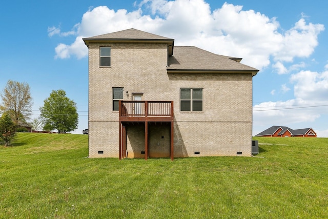 rear view of property with brick siding, crawl space, and a lawn