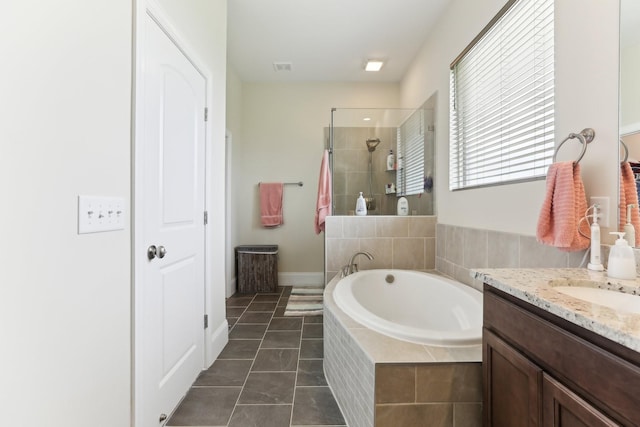 full bathroom featuring a bath, tile patterned floors, a tile shower, visible vents, and vanity