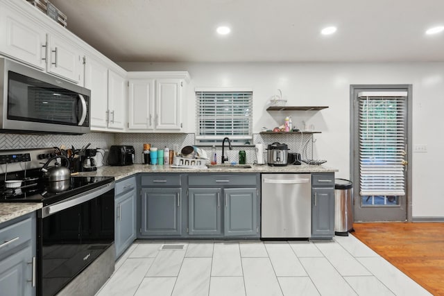 4726 Hickory Ln, Murfreesboro, TN 37129 - kitchen featuring stainless steel appliances, gray cabinets, a sink, decorative backsplash, and white cabinetry