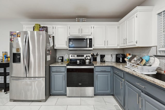 4726 Hickory Ln, Murfreesboro, TN 37129 - kitchen with appliances with stainless steel finishes, white cabinets, light stone countertops, and decorative backsplash