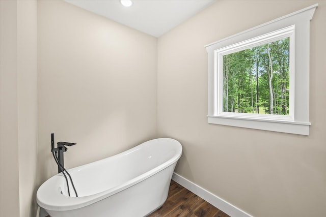 305 Georgee Rd, Jamestown, TN 38556 - bathroom featuring baseboards, a freestanding tub, and wood finished floors