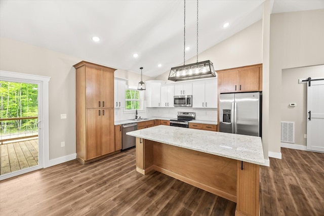 305 Georgee Rd, Jamestown, TN 38556 - kitchen with stainless steel appliances, a sink, a center island, high vaulted ceiling, and a barn door