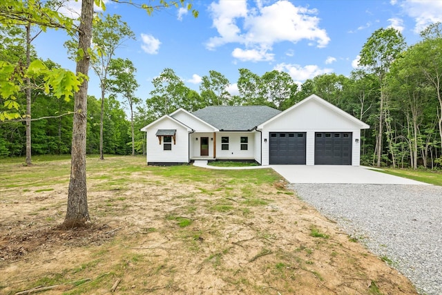 305 Georgee Rd, Jamestown, TN 38556 - modern inspired farmhouse featuring an attached garage, driveway, a front yard, and roof with shingles