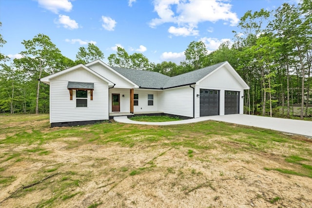 305 Georgee Rd, Jamestown, TN 38556 - modern farmhouse with a garage, concrete driveway, covered porch, and a shingled roof