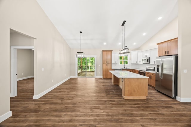 305 Georgee Rd, Jamestown, TN 38556 - kitchen with appliances with stainless steel finishes, high vaulted ceiling, a center island, dark wood-type flooring, and baseboards