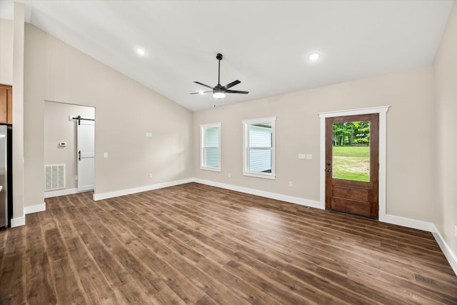 305 Georgee Rd, Jamestown, TN 38556 - unfurnished living room featuring a ceiling fan, dark wood-type flooring, vaulted ceiling, baseboards, and a barn door