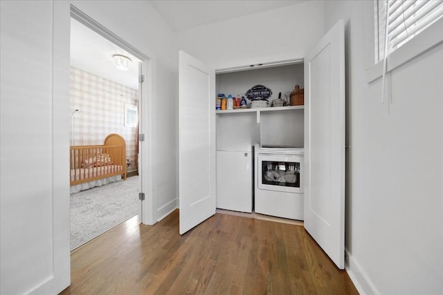 2123A 14th Ave N, Nashville, TN 37208 - clothes washing area with baseboards, wood finished floors, washer and dryer, and laundry area