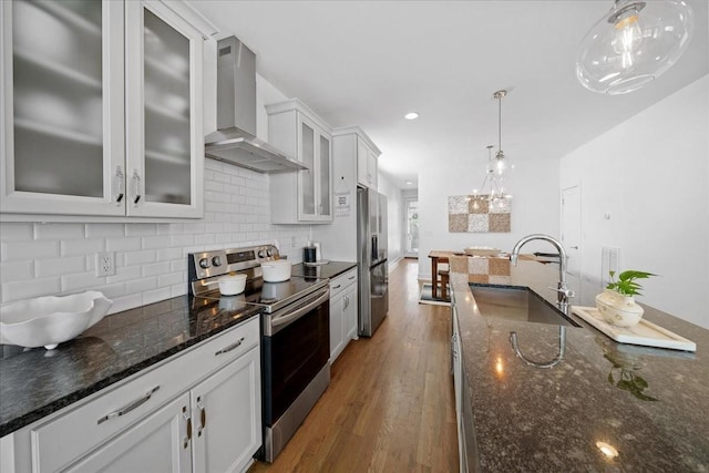 2123A 14th Ave N, Nashville, TN 37208 - kitchen with wall chimney exhaust hood, stainless steel appliances, a sink, decorative backsplash, and wood finished floors