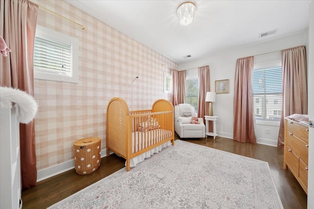 2123A 14th Ave N, Nashville, TN 37208 - bedroom with visible vents, wallpapered walls, wood finished floors, and baseboards
