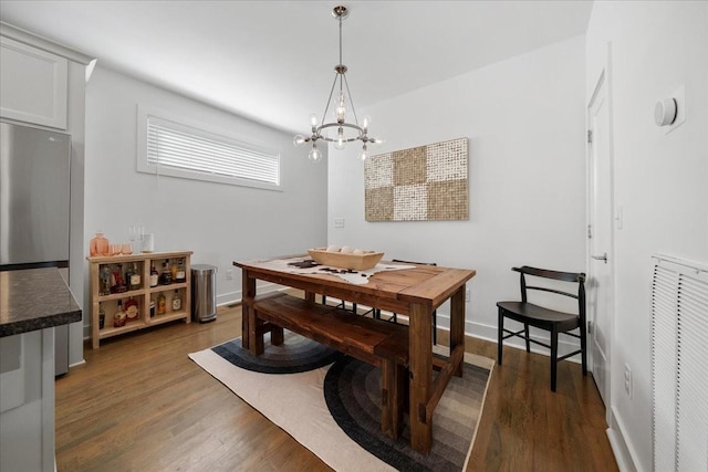 2123A 14th Ave N, Nashville, TN 37208 - dining area featuring visible vents, baseboards, dark wood-style floors, and an inviting chandelier