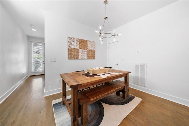 2123A 14th Ave N, Nashville, TN 37208 - dining area featuring an inviting chandelier, wood finished floors, visible vents, and baseboards
