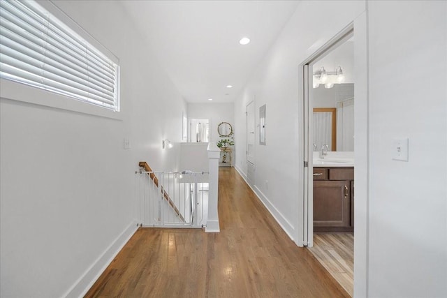 2123A 14th Ave N, Nashville, TN 37208 - corridor with a sink, an upstairs landing, light wood-style floors, baseboards, and recessed lighting