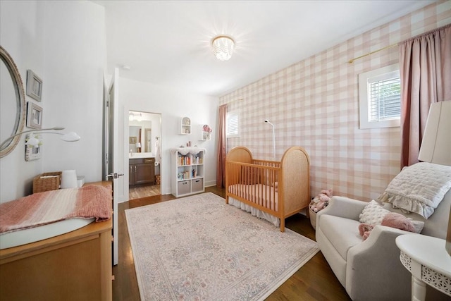 2123A 14th Ave N, Nashville, TN 37208 - bedroom featuring wallpapered walls, wood finished floors, and multiple windows
