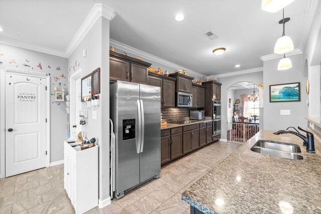 1438 Millet Dr, Clarksville, TN 37040 - kitchen with stainless steel appliances, a sink, dark brown cabinetry, arched walkways, and crown molding